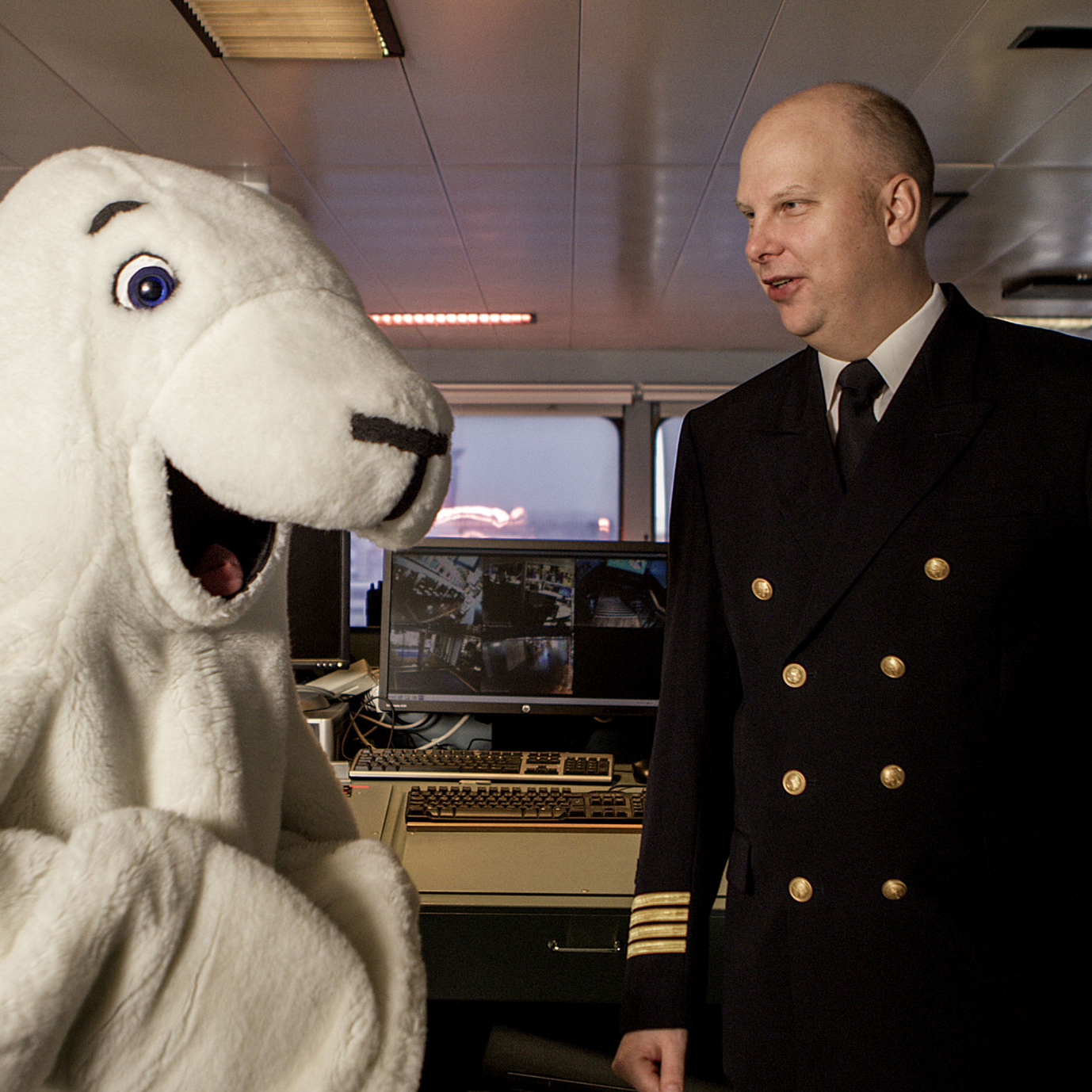 Ship’s captain looks through binoculars on the bridge.