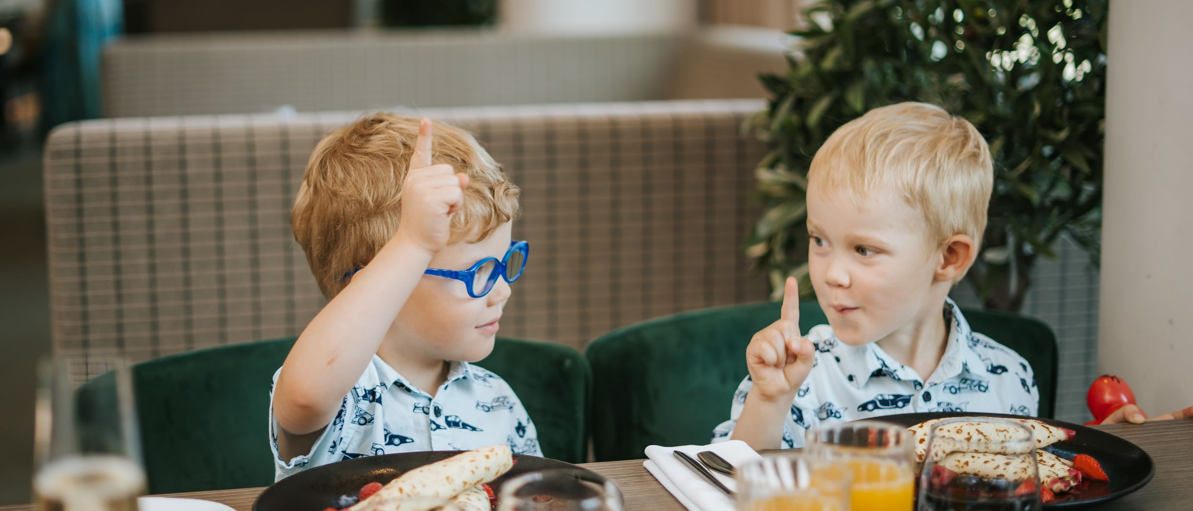 Two children sitting at a table at Nero restaurant