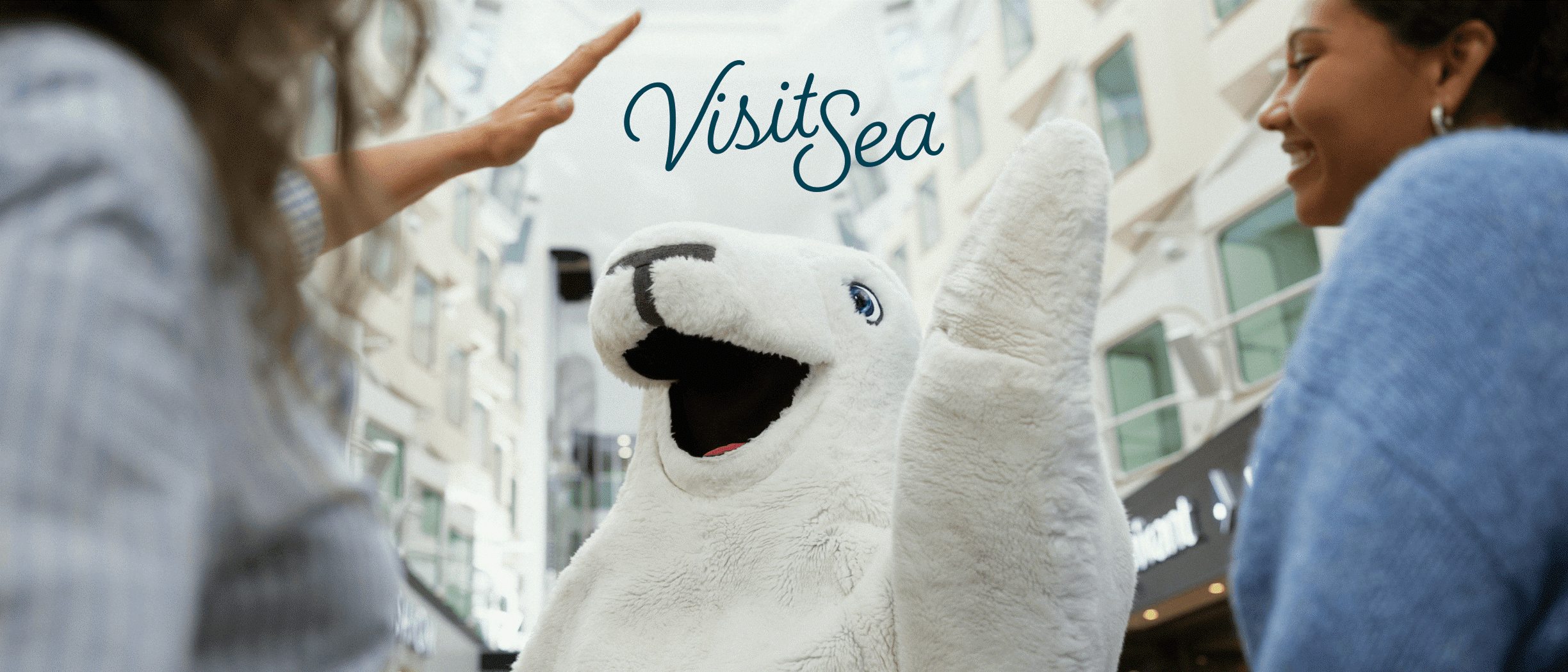 Visit Sea campaign image featuring Harri the Seal greeting travelers on board a Tallink Silja Line ship.