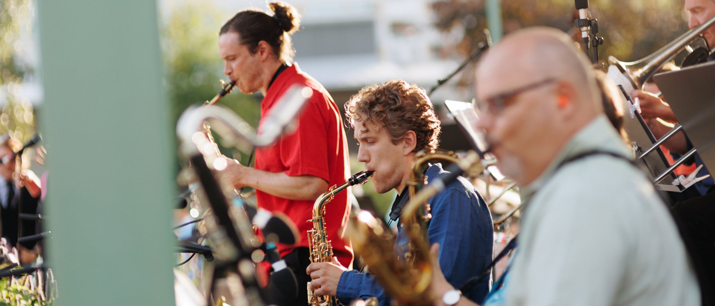 Musicians perform live during Night of the Arts in Helsinki, playing brass instruments in a lively outdoor setting.