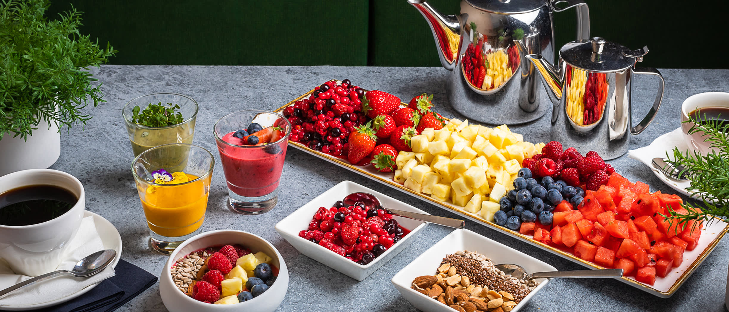 A colourful conference catering setup on a Tallink ship, featuring fresh fruit, smoothies, coffee and tea served for meeting guests.