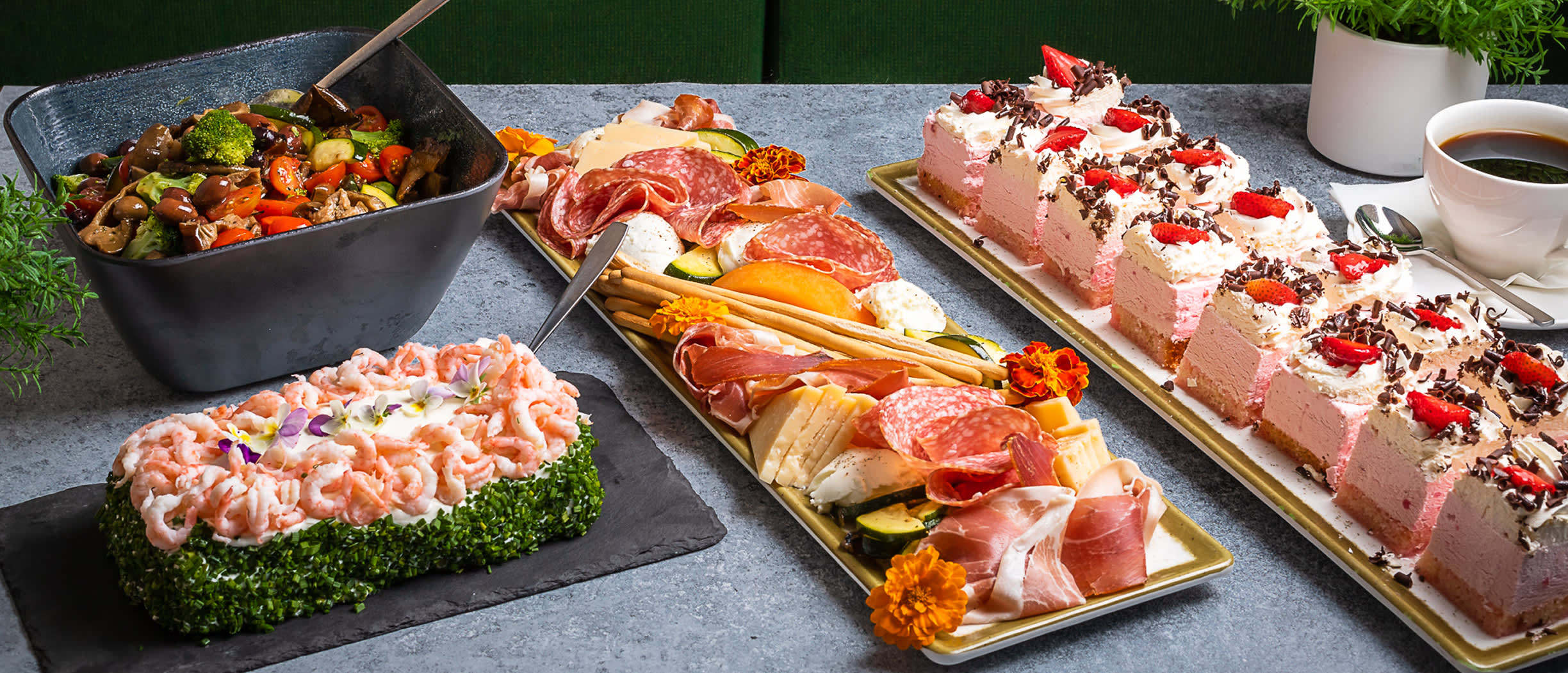 A colourful conference catering table on Silja Symphony, featuring fresh salads, cold cuts, desserts and coffee – a perfect spread for meetings at sea.