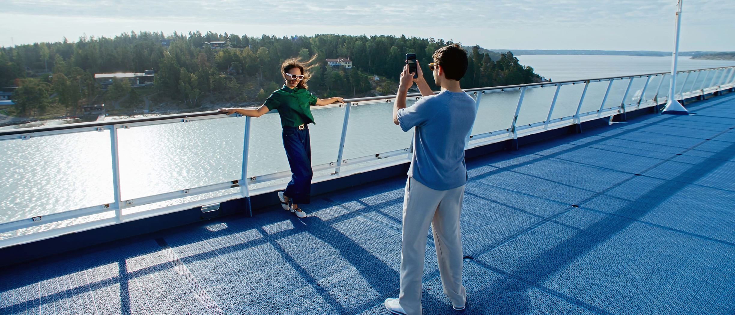 Couple on deck taking photos
