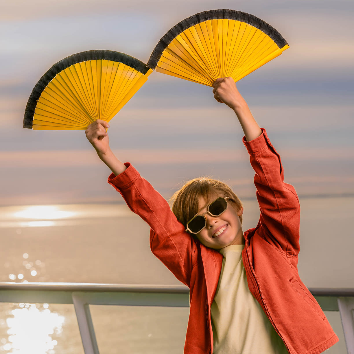 A child with fans taking part in FriendSHIP experience package activities.