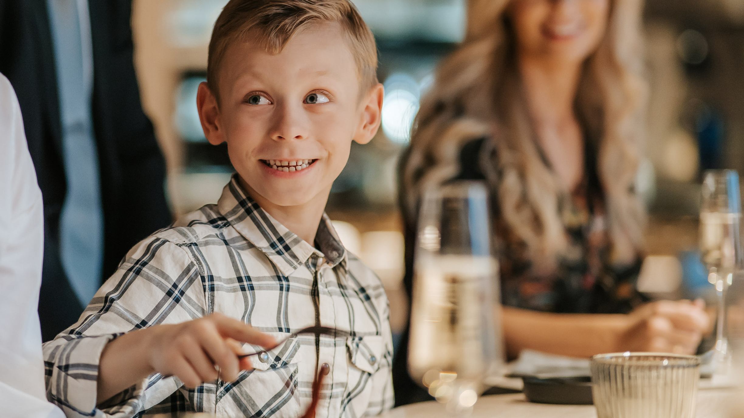 Boy eating at a table in a restaurant