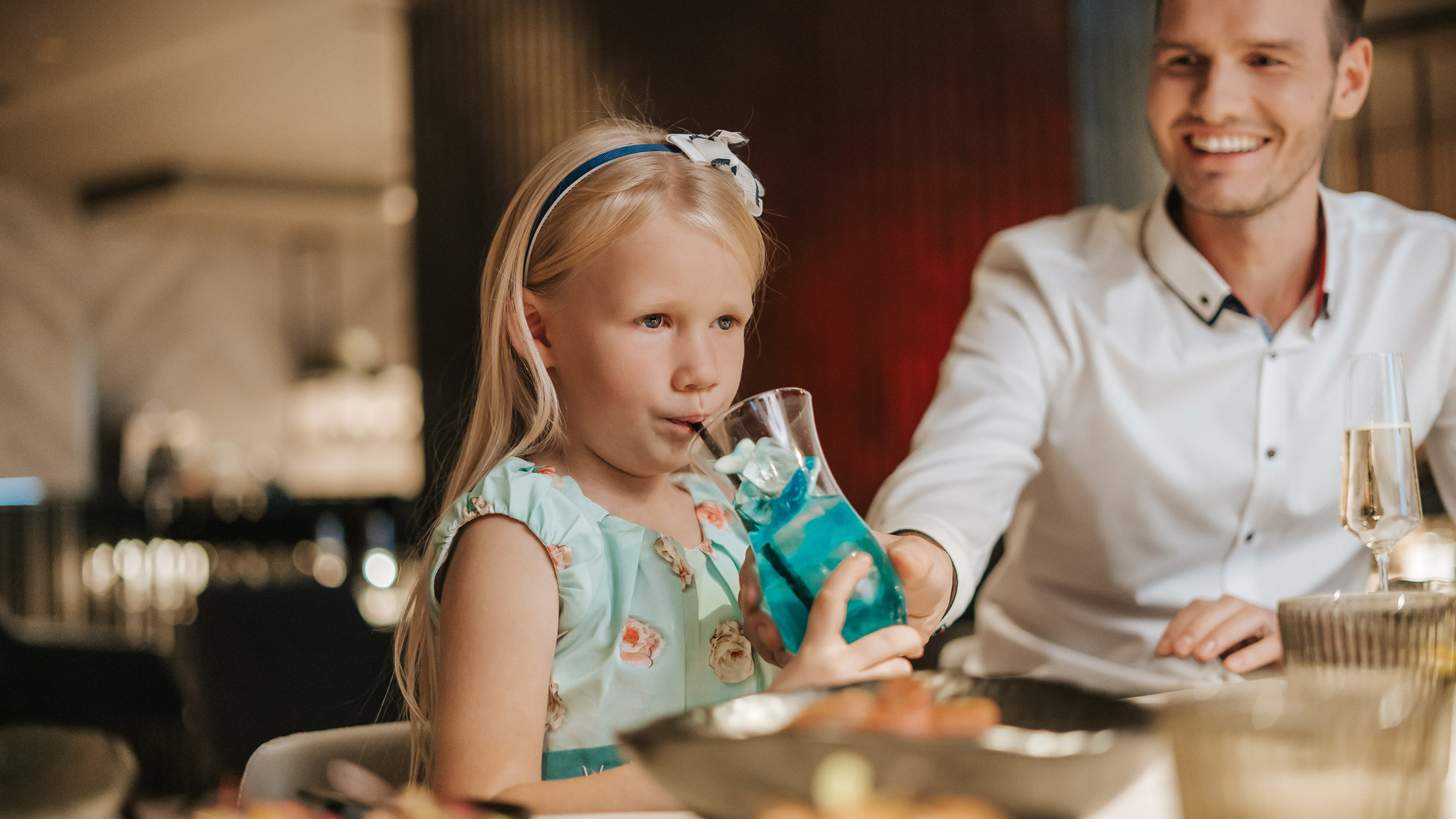Girl drinking a children's cocktail in a restaurant