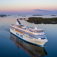 Silja Symphony seilaa Itämeren saaristossa auringon laskiessa