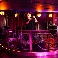 En tjej står på scen och sjunger karaoke på kryssning till Åbo